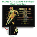 Black framed canvas soccer wall art with a running player, soccer ball, and colorful motivational design