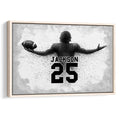 Framed football wall art featuring a monochrome player silhouette holding a football