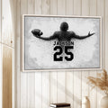 Framed football wall art displayed on a light wood-paneled wall in a neutral room