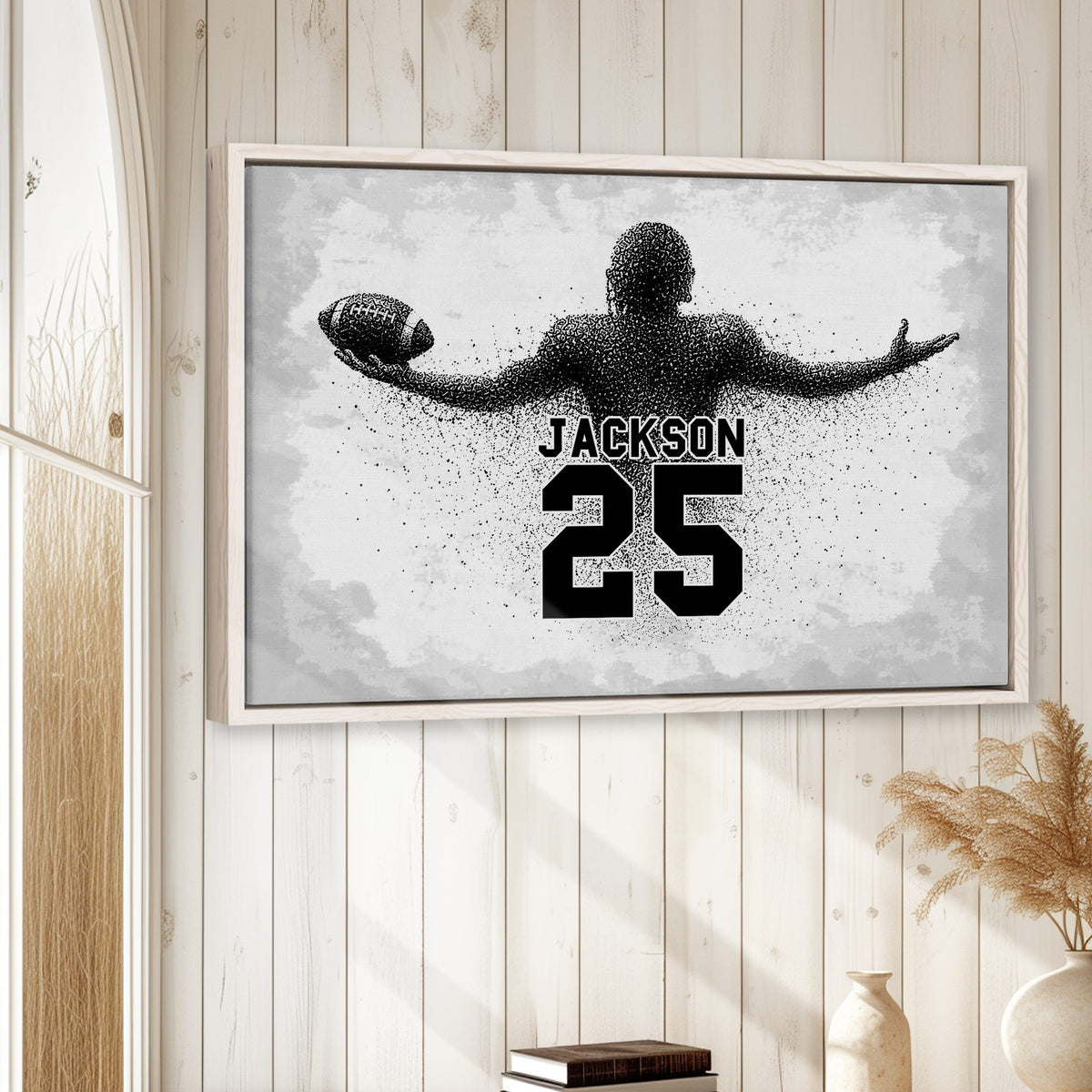 Framed football wall art displayed on a light wood-paneled wall in a neutral room