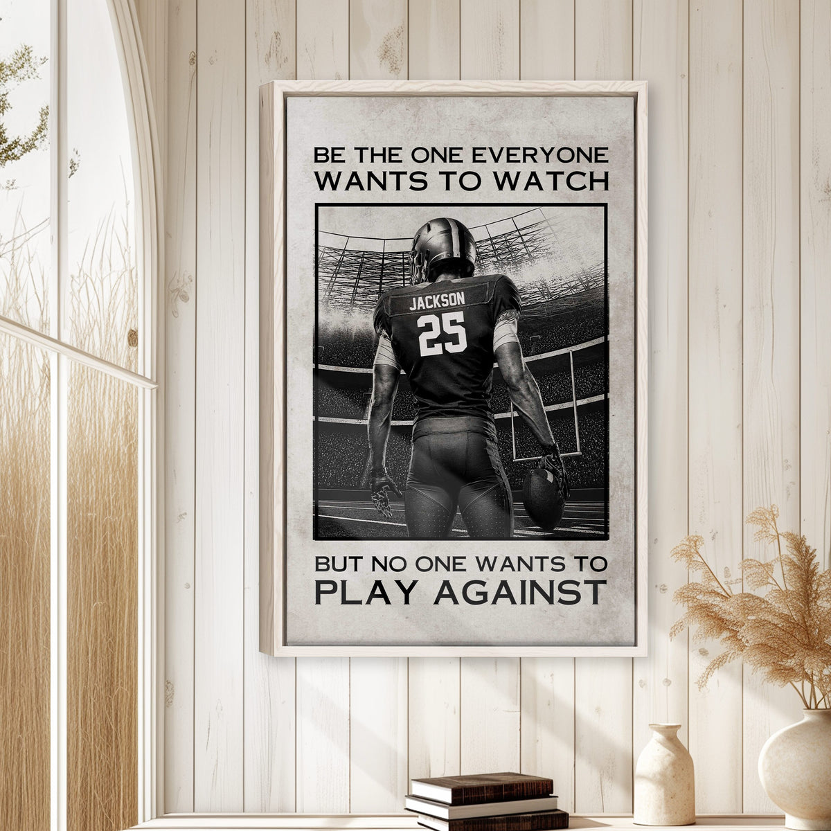 Framed football wall art displayed on a light wood-paneled wall in a bright home interior