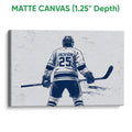 Matte canvas hockey wall art showing a back-view player and stick in a textured navy and white design
