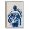 Framed soccer wall art showing a player from behind with a ball and blue painted background