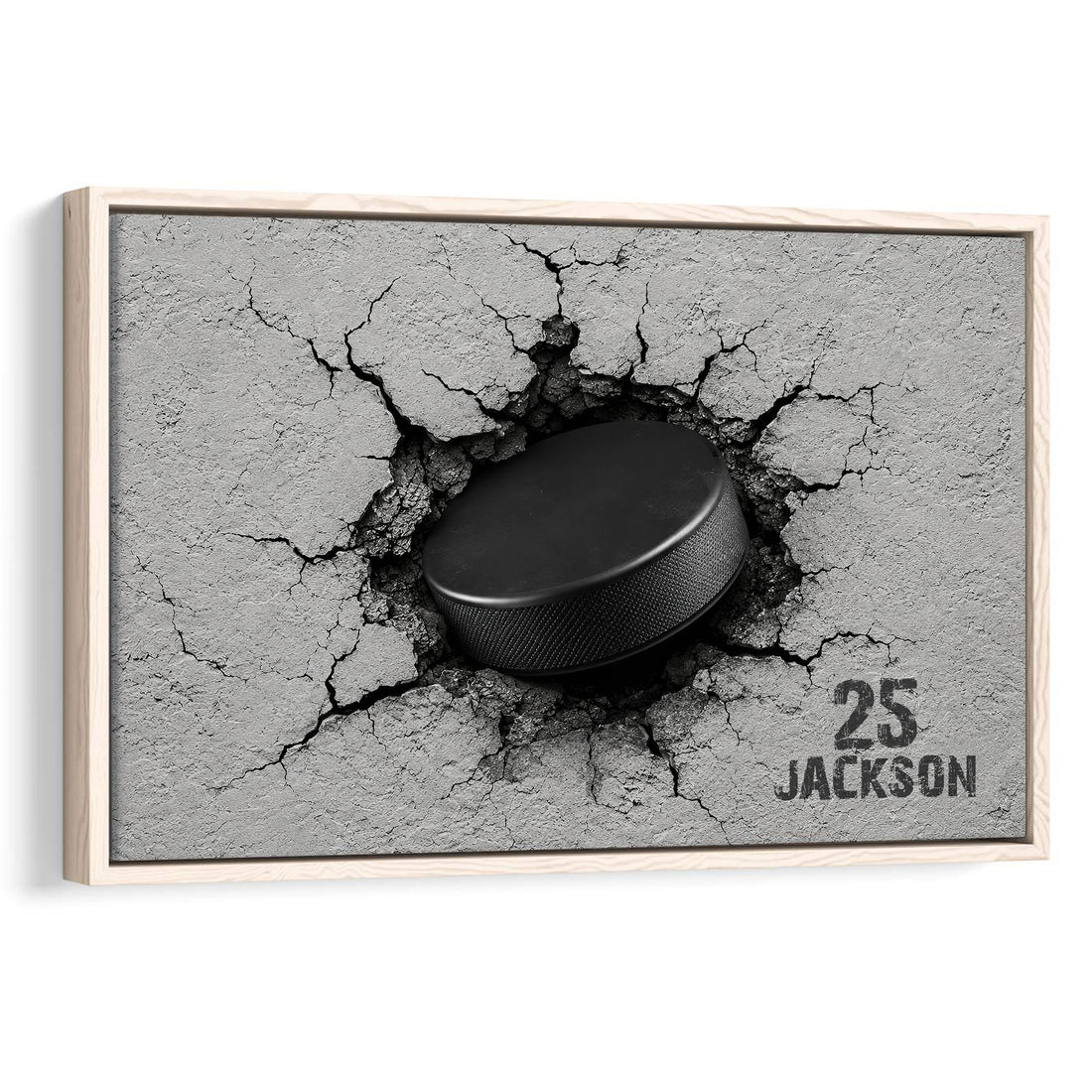 Framed hockey wall art featuring a black puck breaking through a cracked gray surface