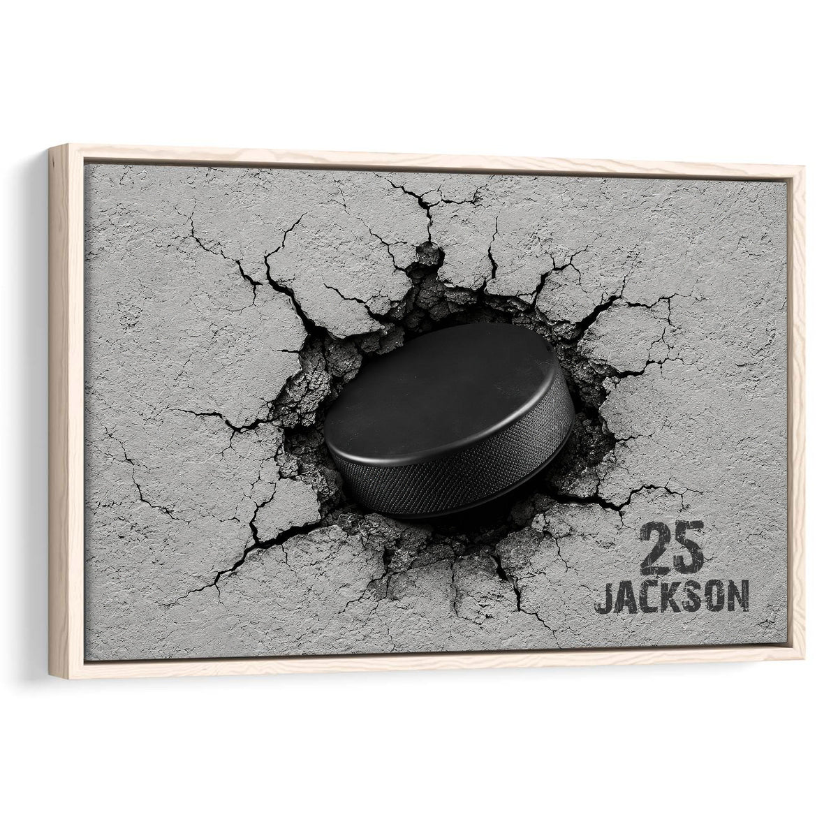 Framed hockey wall art featuring a black puck breaking through a cracked gray surface