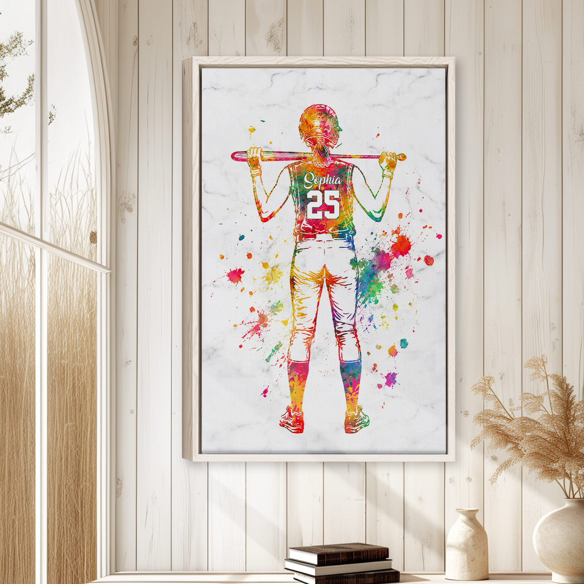 Colorful framed softball wall art displayed on a light wood-paneled wall in a bright home interior