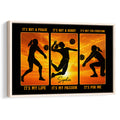 Framed volleyball wall art with three player silhouettes against a vivid orange sunset