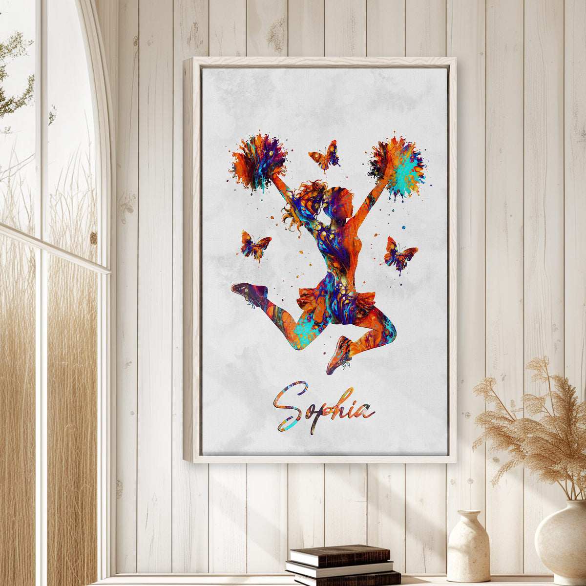 Cheerleading wall art displayed in a bright room with white wood paneling and natural decor