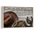 Framed cowboy wall art with a brown hat, rope, horseshoes and rustic Western typography