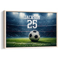 Framed soccer wall art featuring a ball on a brightly lit stadium field