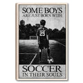 Framed soccer wall art showing a young player with a ball on an outdoor field in monochrome style