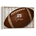 Framed football wall art featuring a detailed brown football against rustic white wood