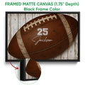 Black framed football canvas wall art with a brown football and close-up frame detail