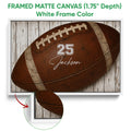 White framed football canvas wall art with a brown football and detailed frame close-up