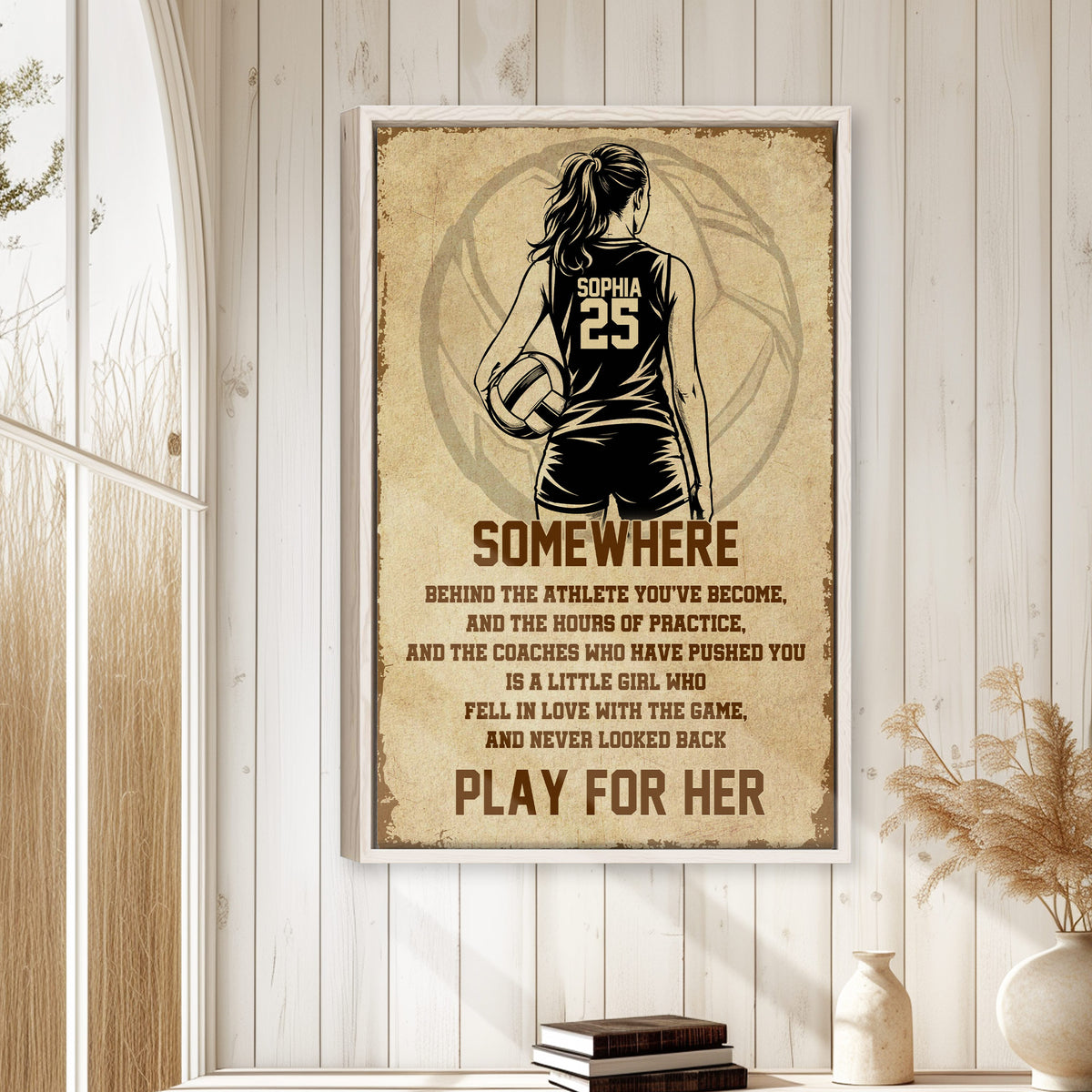 Framed volleyball wall art displayed on a light wood-paneled wall in a bright home interior