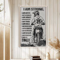 Motocross wall art displayed in a bright wood-paneled room above a small stack of books