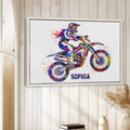Framed motocross wall art displayed on a light wood-paneled interior wall