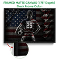 Black framed canvas soccer wall art with a player, soccer ball, and dark red and blue artwork