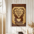 Framed deer wall art displayed on a white paneled wall in a warm rustic home entryway