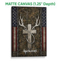 Matte canvas hunting wall art featuring white deer antlers over a dark woodland camouflage background