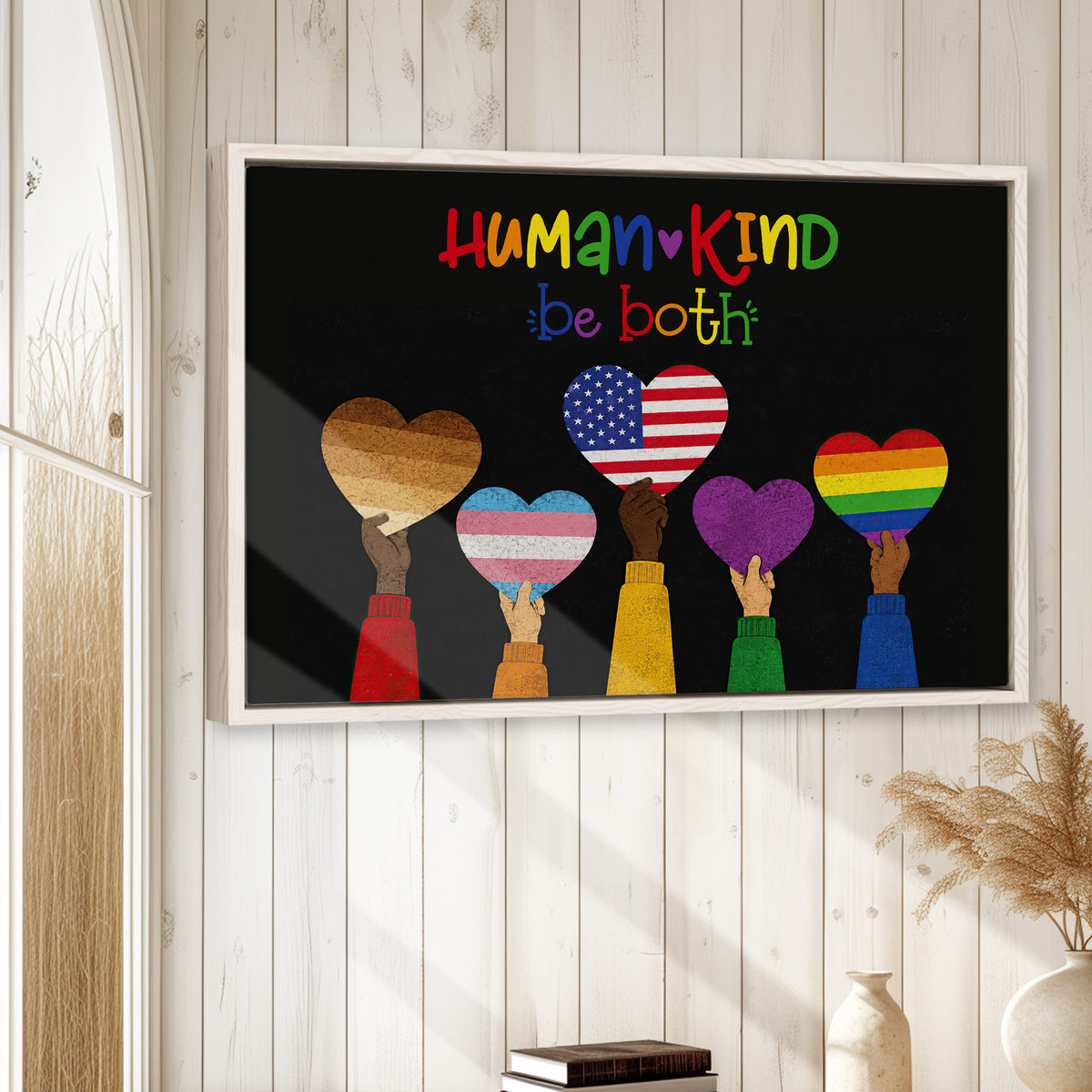 LGBT pride wall art displayed in a bright home with colorful hearts and inclusive messaging