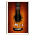 Framed guitar wall art featuring a close-up acoustic guitar on a warm orange and brown background