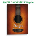 Matte canvas guitar wall art featuring a close-up acoustic guitar in rich orange and brown tones