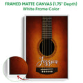 White framed matte canvas guitar wall art with a warm orange acoustic guitar design