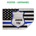 Unframed police badge poster with blue line American flag artwork and a curled paper corner