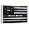 Framed police wall art featuring a rustic black and white flag with a blue line and stars