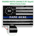 White framed canvas police wall art with a black and white flag and blue line