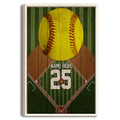 Framed softball wall art with a large yellow softball, green field design, and rustic woodgrain background