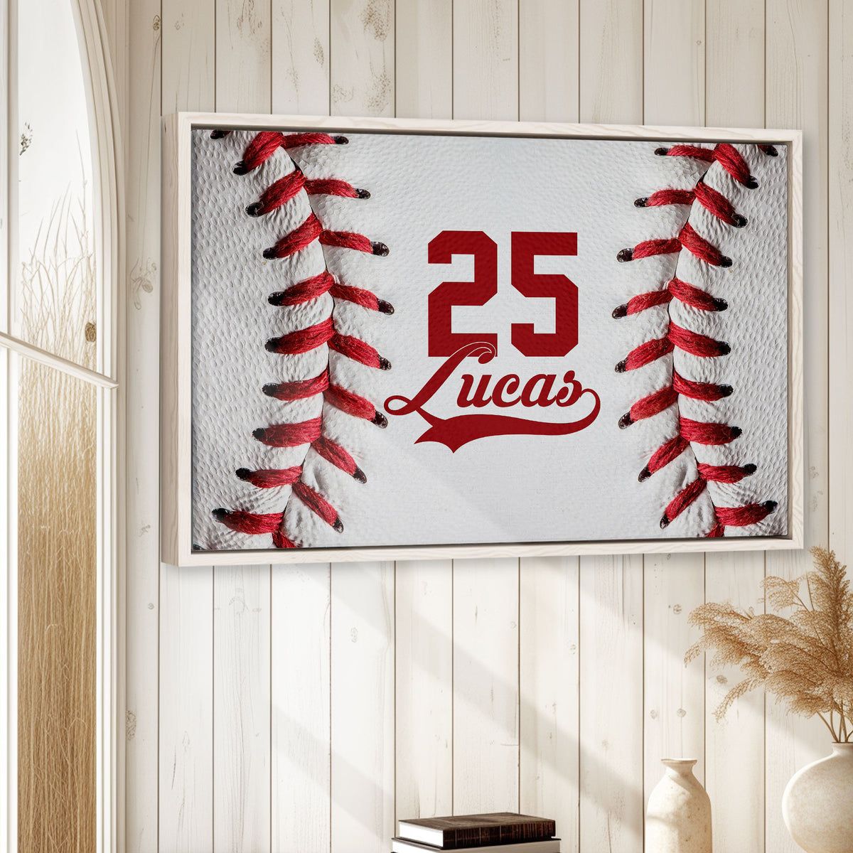 Framed baseball wall art displayed on a light wood paneled wall in a bright room