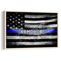 Framed police wall art featuring a distressed black and white flag with a vivid blue stripe