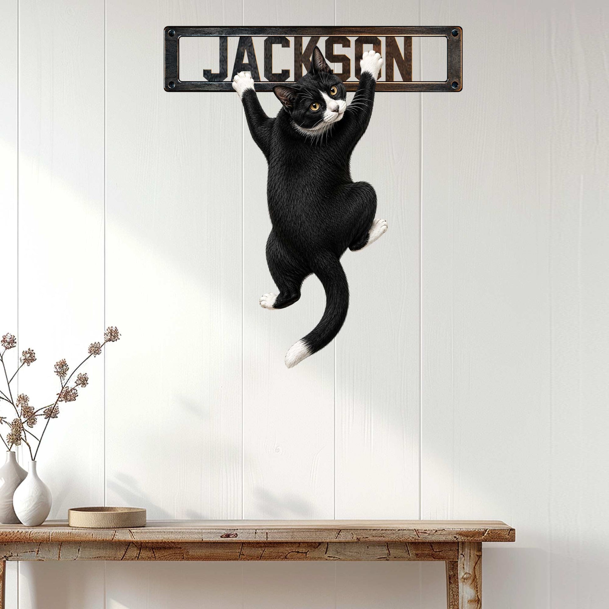Tuxedo cat wall sign displayed above a console table in a bright, modern home interior