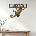 Chameleon wall sign displayed on a white paneled wall above a rustic console table