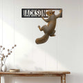 Squirrel wall sign displayed on a white paneled wall above a rustic console table