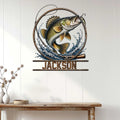 Fishing wall decor displayed on a light wood wall, featuring a bass leaping through waves and fishing gear