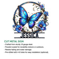 Decorative butterfly metal sign with brilliant blue wings, floral accents, and a graceful botanical frame