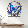 Blue butterfly wall sign displayed on a light paneled wall above a wood console table