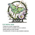 Green moth cut metal sign with botanical details, crescent moon, floral accents, and decorative finish