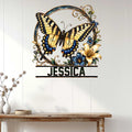 Decorative butterfly metal sign displayed on a white paneled wall above a console table