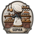 Baker metal sign featuring a pastry chef surrounded by breads, cupcakes, cookies, and baking shelves