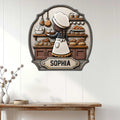 Baker metal sign displayed on a white paneled wall above a rustic console table