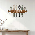 Rustic kitchen wall sign displayed on white paneling above a console table in a bright home interior