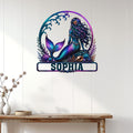 Mermaid wall sign displayed on a light paneled wall above a console table in a coastal-style room