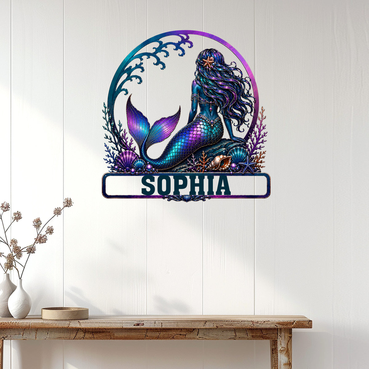 Mermaid wall sign displayed on a light paneled wall above a console table in a coastal-style room
