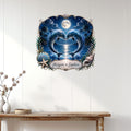Dolphin couple wall decor displayed on a light wood wall above a console table