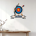 Archery wall sign displayed on a light paneled wall above a rustic console table