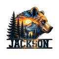 Custom bear metal sign featuring a detailed bear portrait over evergreen forest, mountains, lake, and sunset scenery